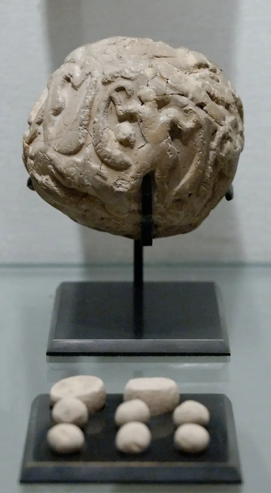 Sumerian clay accounting envelope with its token counters, from the Louvre